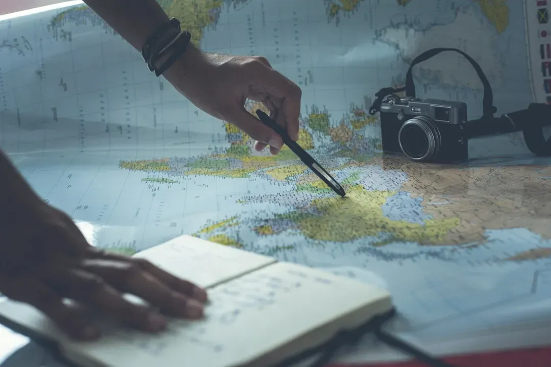 a solo traveller using a map or guidebook to navigate a city